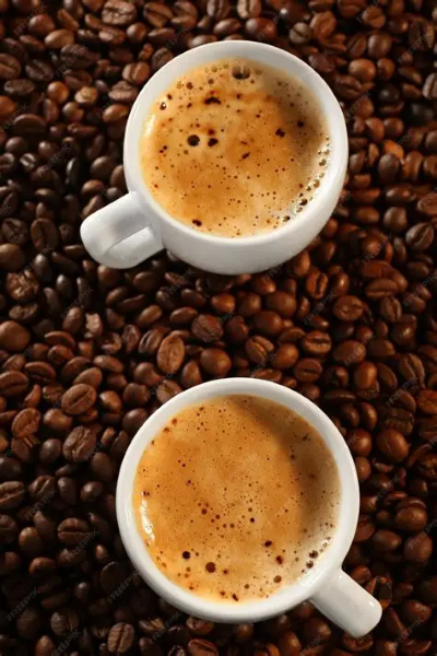 Bean-to-cup coffee vending machine pouring fresh espresso into a ceramic cup on roasted coffee beans